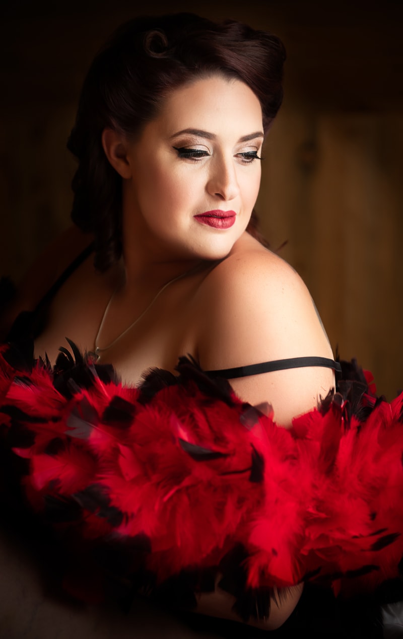 Boudoir Photography, woman in lingerie and feather boa stands